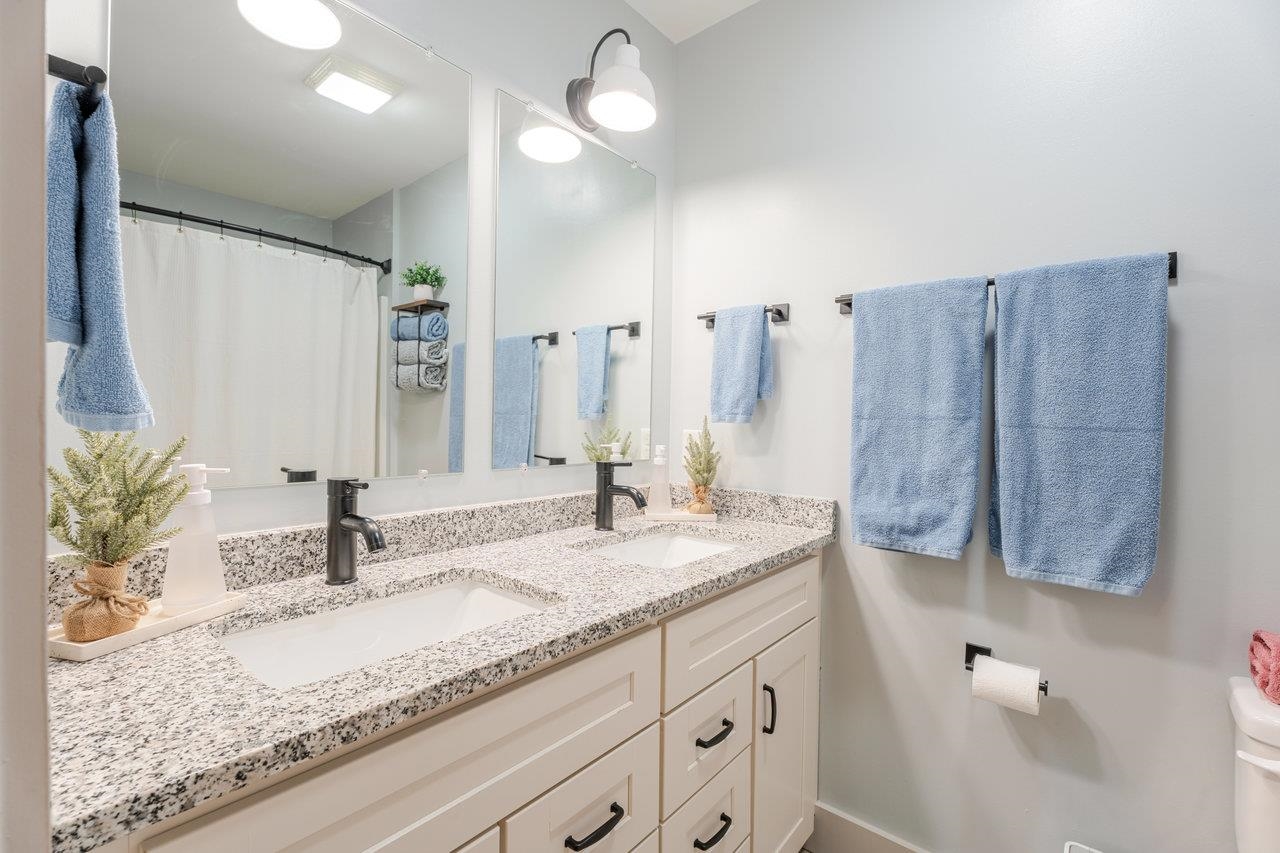 34 Field Court Bridgewater, VA 22812 - Photo 34 of 42 a bathroom with a granite countertop sink and a mirror