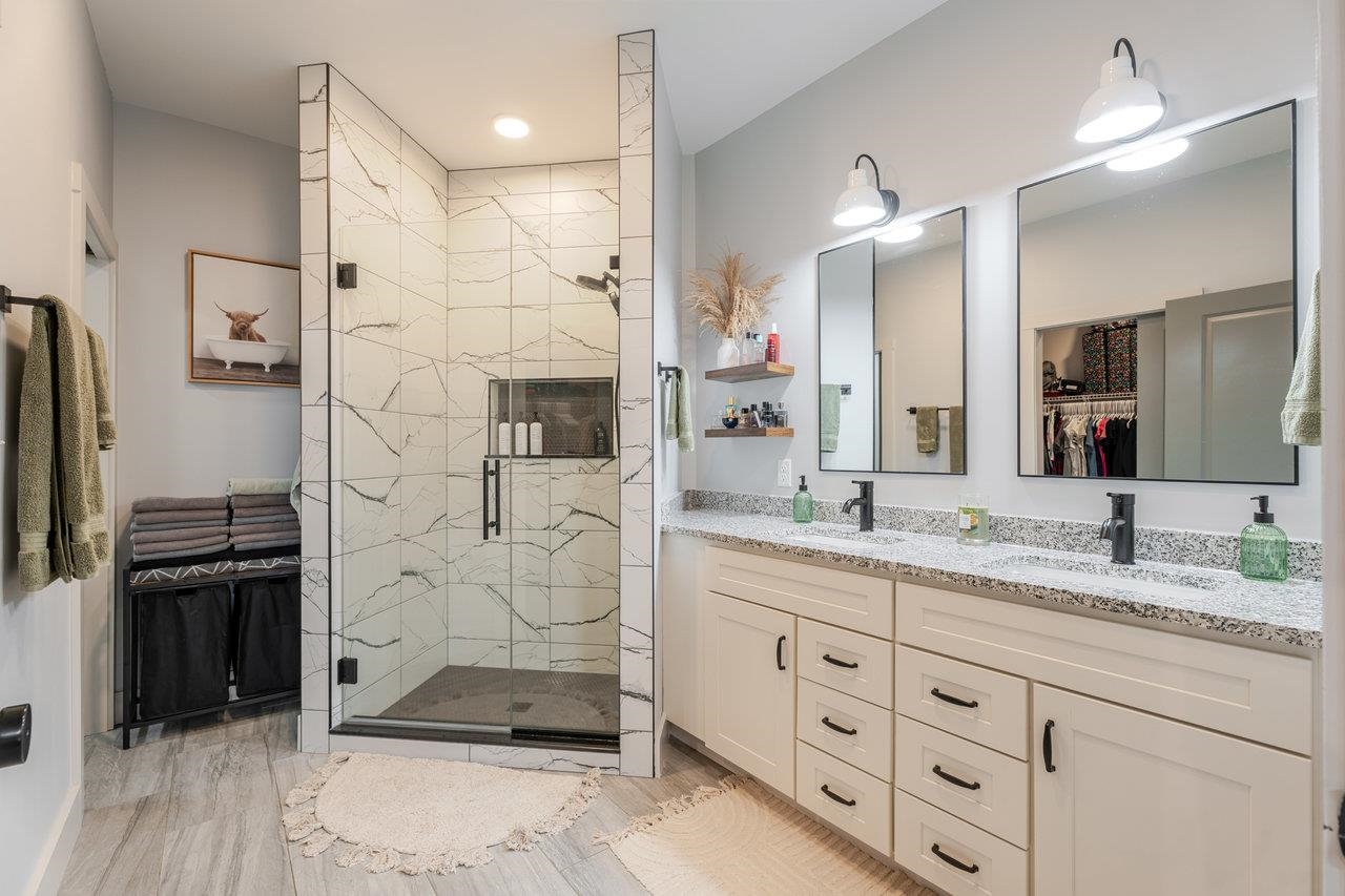 34 Field Court Bridgewater, VA 22812 - Photo 9 of 42 a bathroom with a granite countertop sink mirror and shower