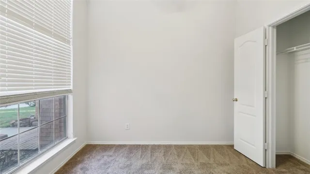 a view of small space with wooden floor and a window