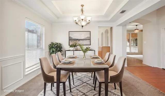 a view of a dining room with furniture wooden floor and chandelier