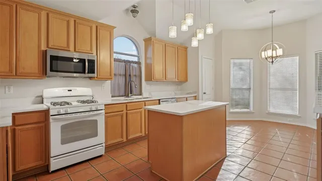 a kitchen with a sink stove and microwave