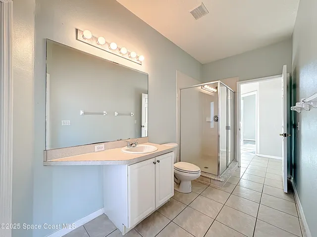 a bathroom with a glass shower door and a glass door