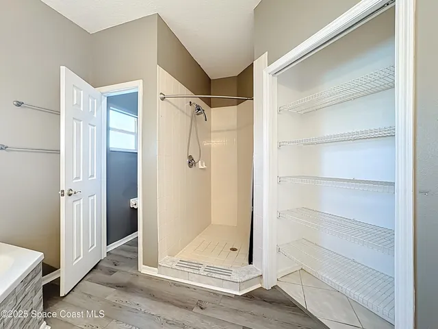 a view of walk in closet with empty racks