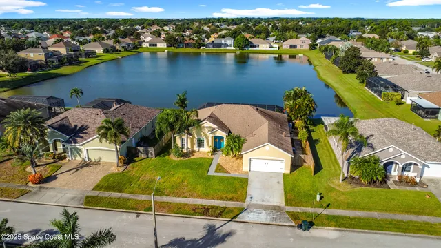 an aerial view of a house with a lake view
