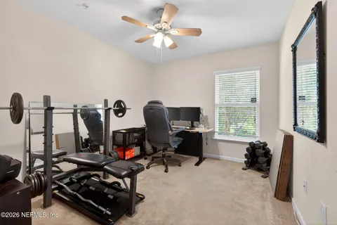a view of a workspace with furniture and a window