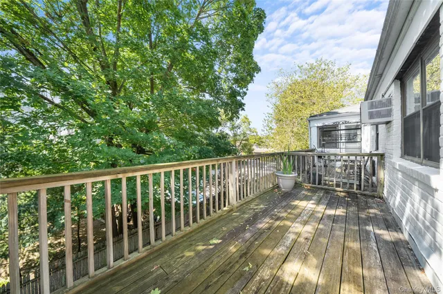 a view of balcony with wooden floor and fence