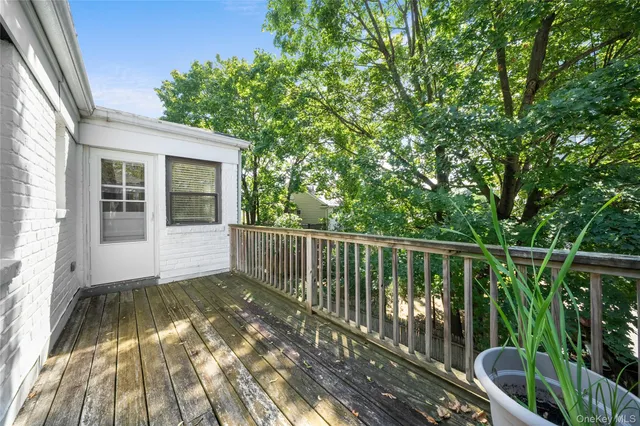 a view of balcony with wooden floor and fence