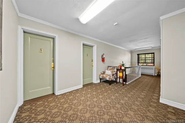 a view of a room with furniture and a window