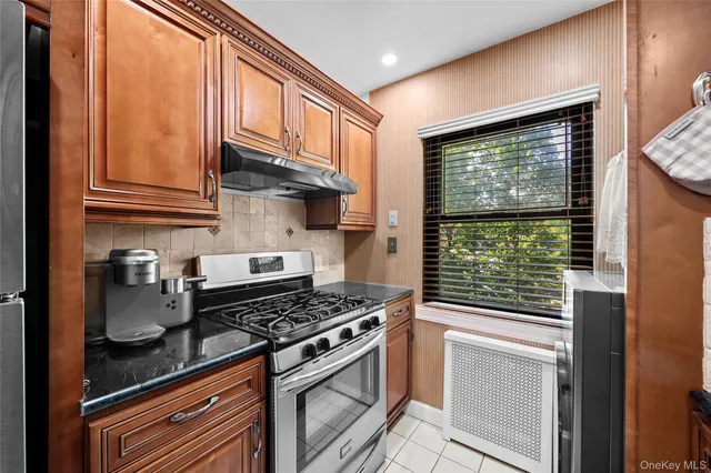 a kitchen with stainless steel appliances granite countertop a stove and a refrigerator