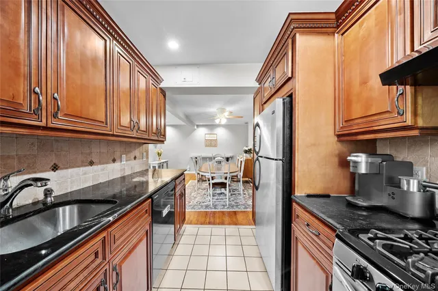 a kitchen with stainless steel appliances granite countertop a stove and a sink