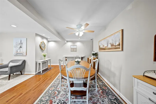 a living room with furniture a piano and a rug