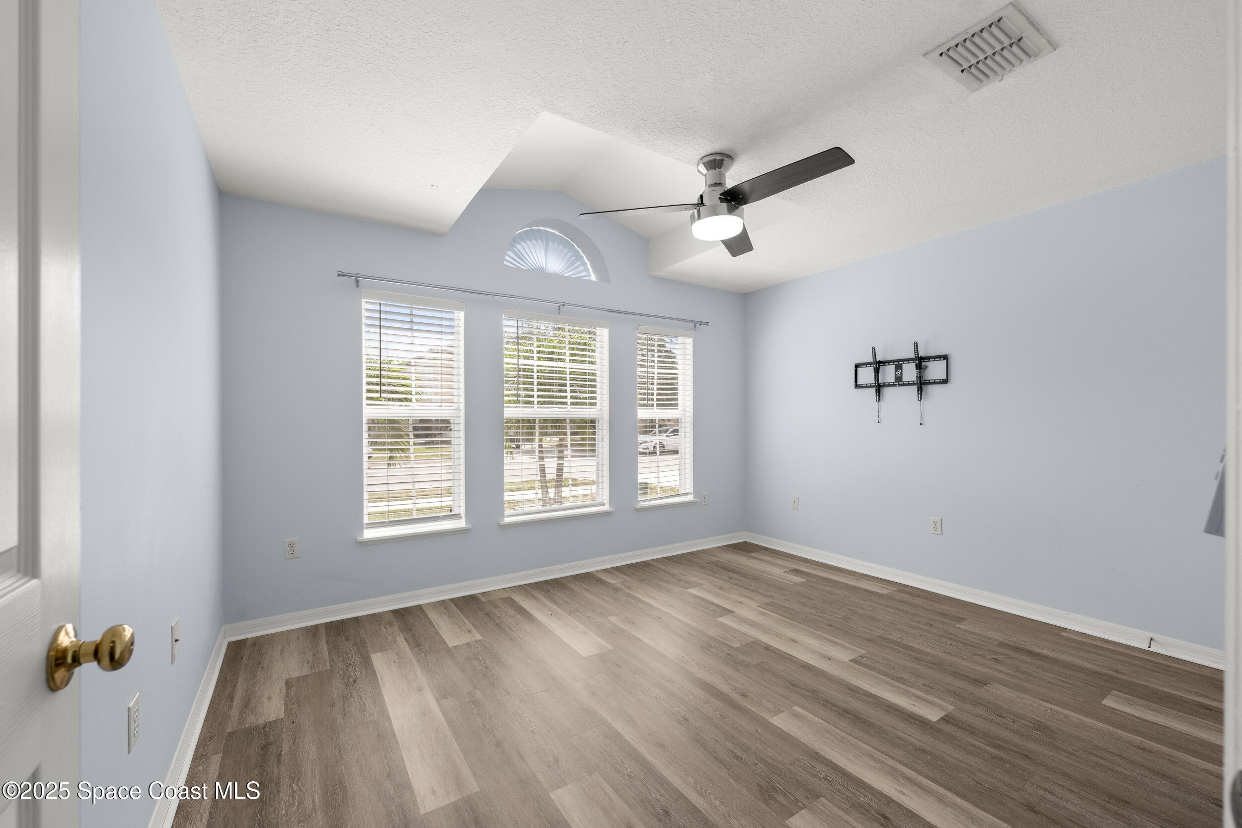 2100 Canopy Drive Melbourne, FL 32935 - Photo 12 of 53 a view of an empty room with a window and wooden floor