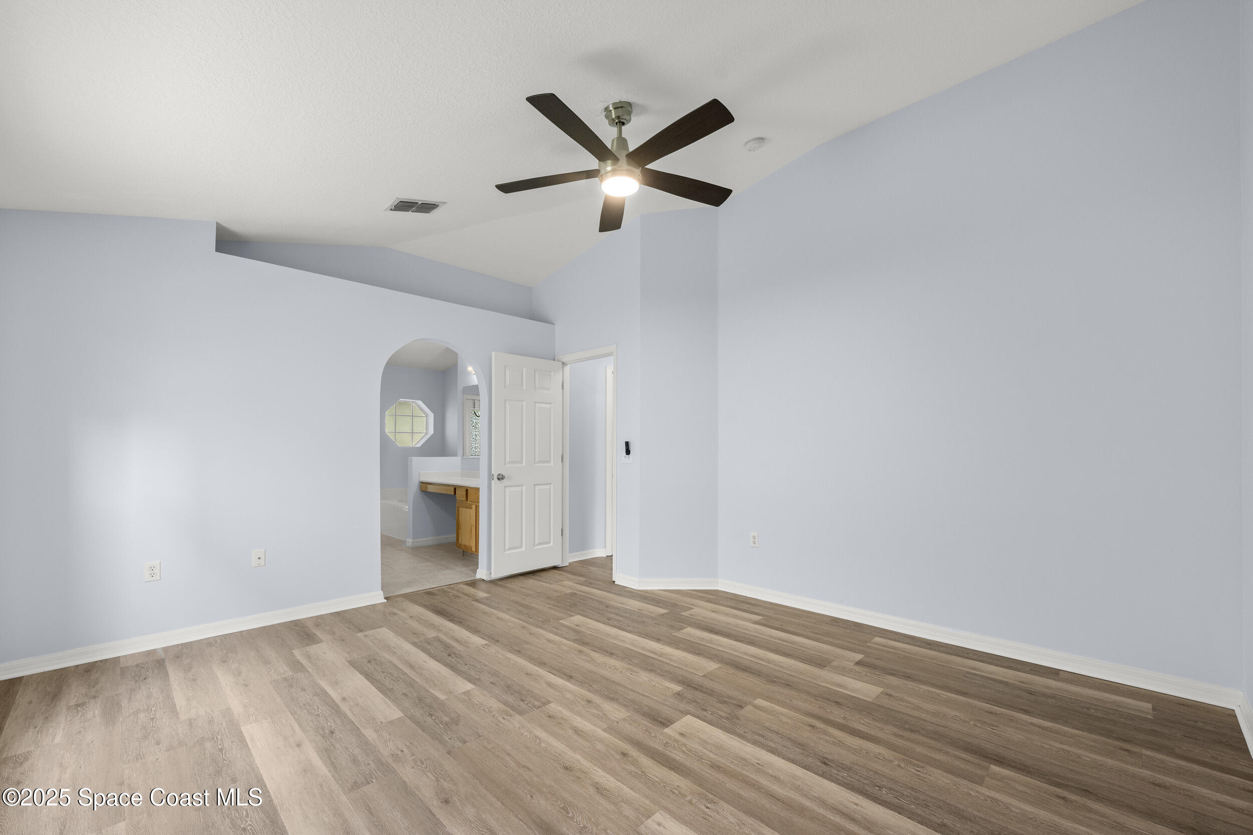 2100 Canopy Drive Melbourne, FL 32935 - Photo 17 of 53 a view of empty room with wooden floor and ceiling fan