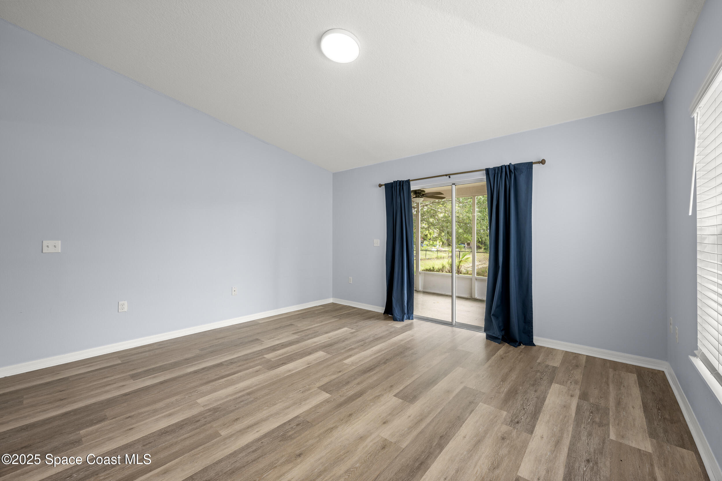2100 Canopy Drive Melbourne, FL 32935 - Photo 27 of 53 a view of an empty room with wooden floor and a window