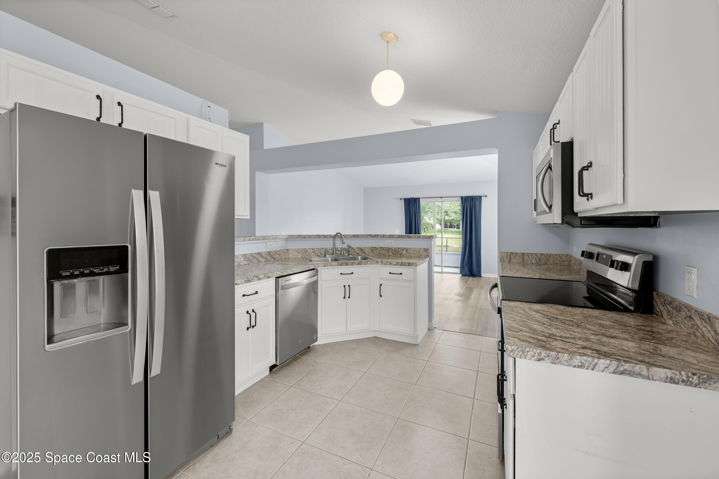 2100 Canopy Drive Melbourne, FL 32935 - Photo 29 of 53 a kitchen with stainless steel appliances granite countertop a refrigerator and a stove