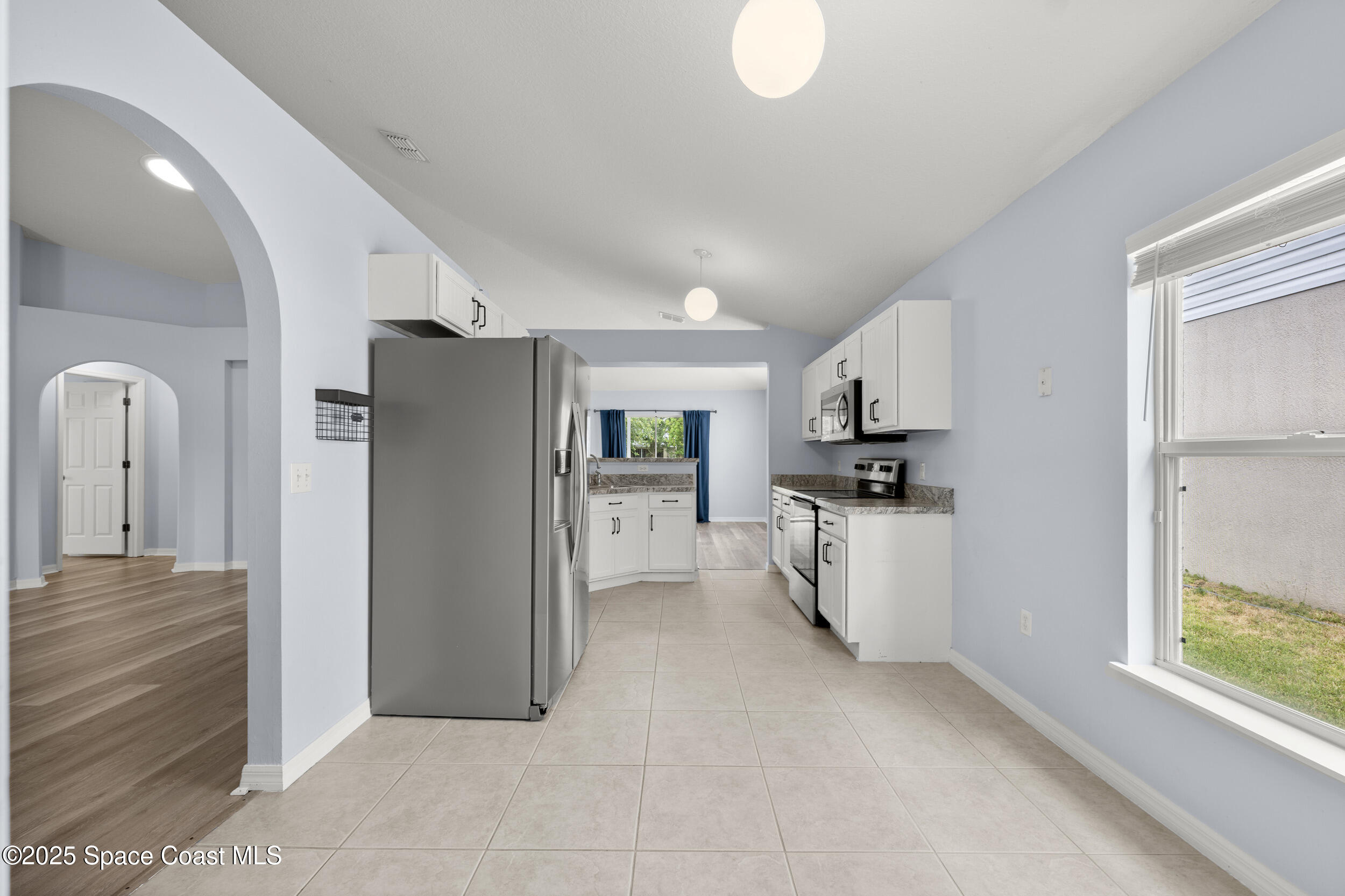 2100 Canopy Drive Melbourne, FL 32935 - Photo 30 of 53 a kitchen with refrigerator and cabinets