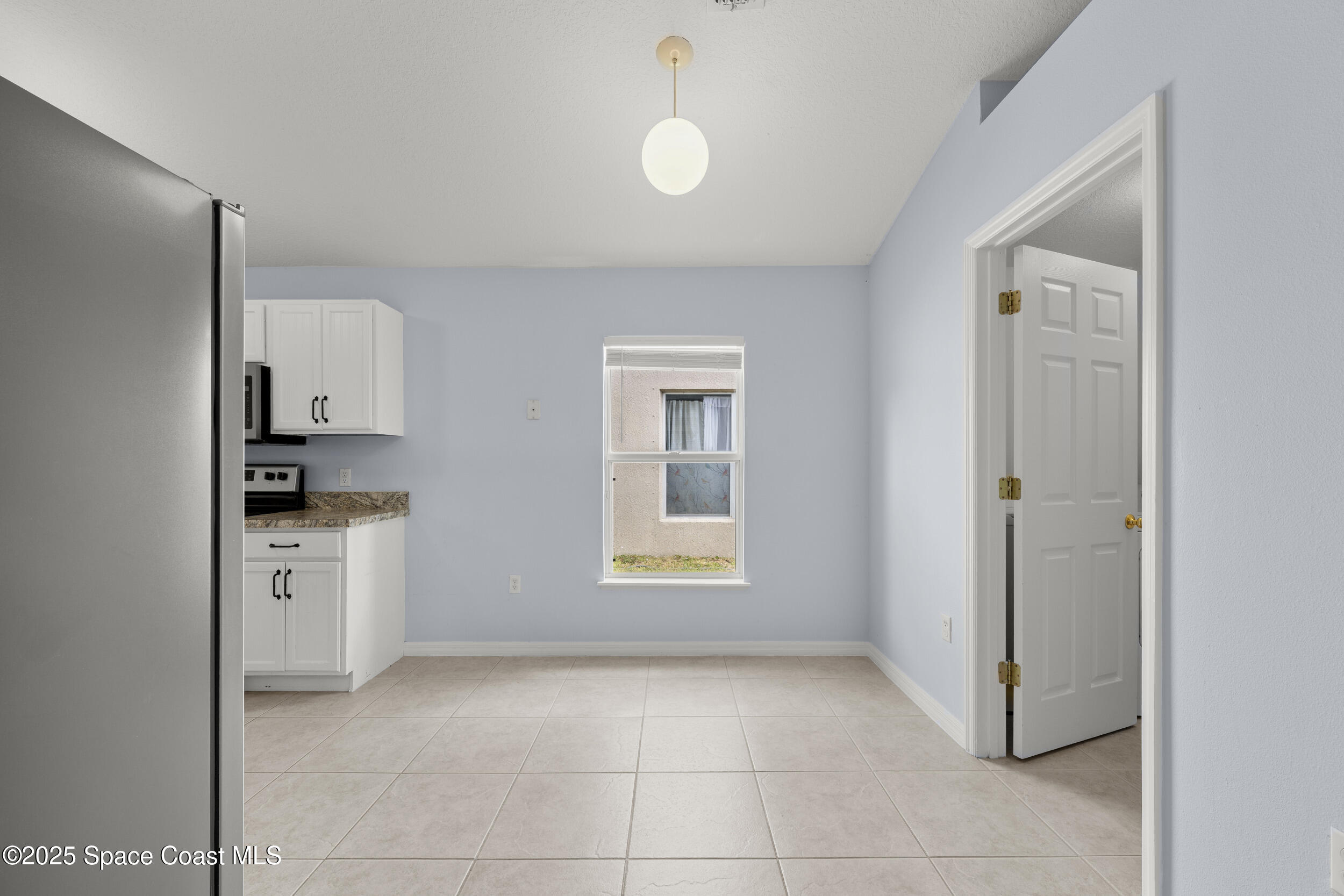 2100 Canopy Drive Melbourne, FL 32935 - Photo 31 of 53 a view of a kitchen with a sink dishwasher and a refrigerator