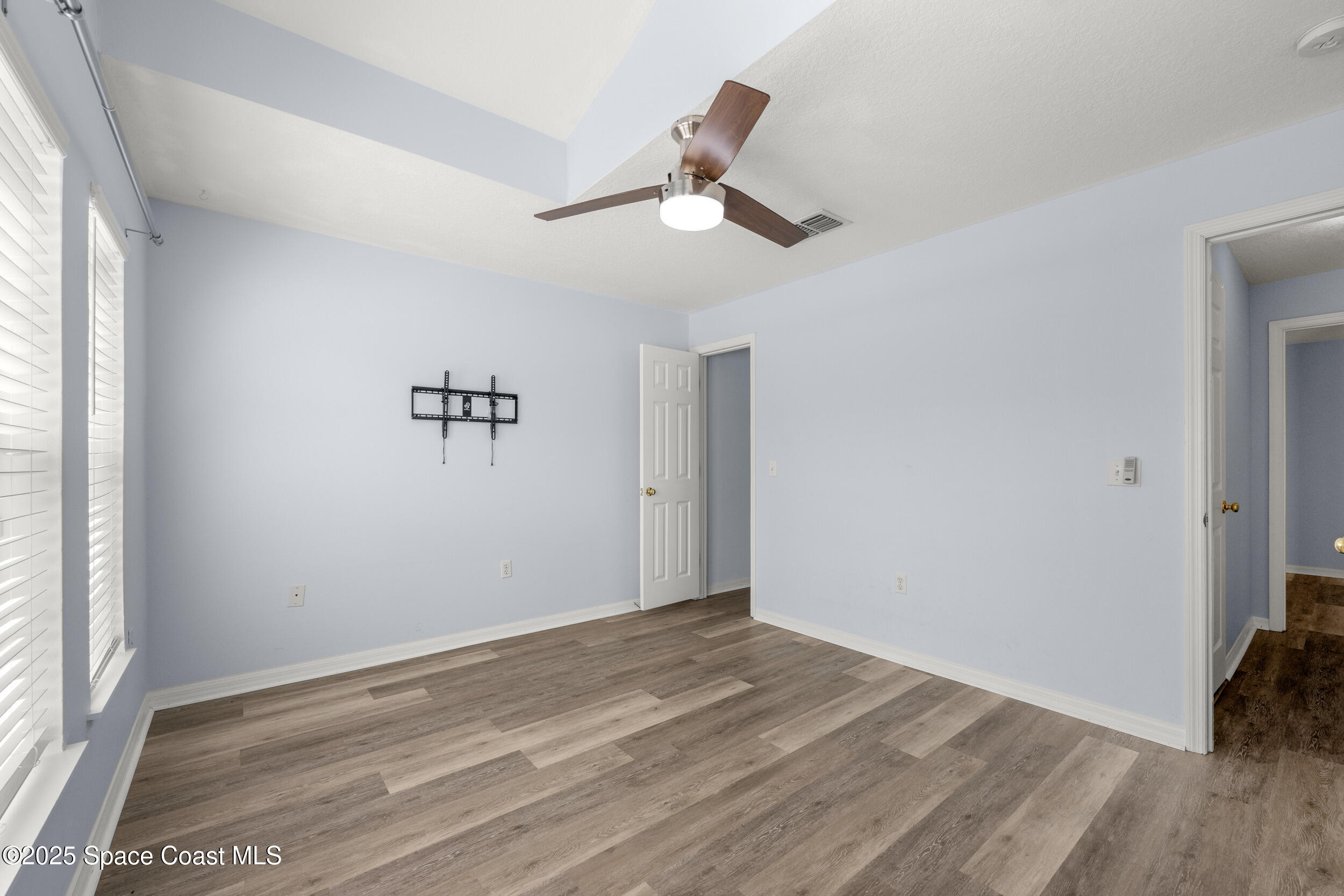 2100 Canopy Drive Melbourne, FL 32935 - Photo 36 of 53 a view of empty room with wooden floor and fan