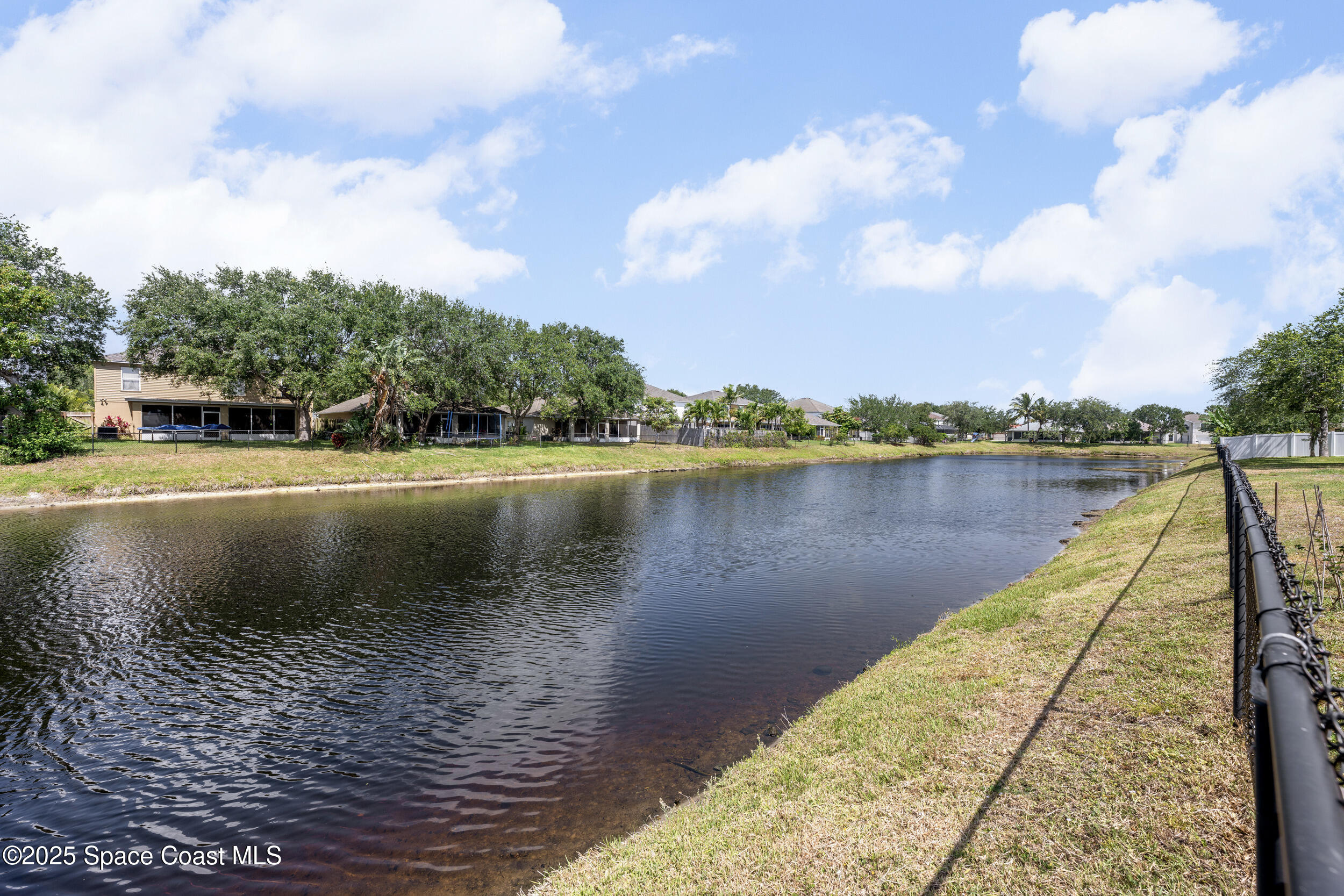 2100 Canopy Drive Melbourne, FL 32935 - Photo 38 of 53 a view of a lake with a large trees