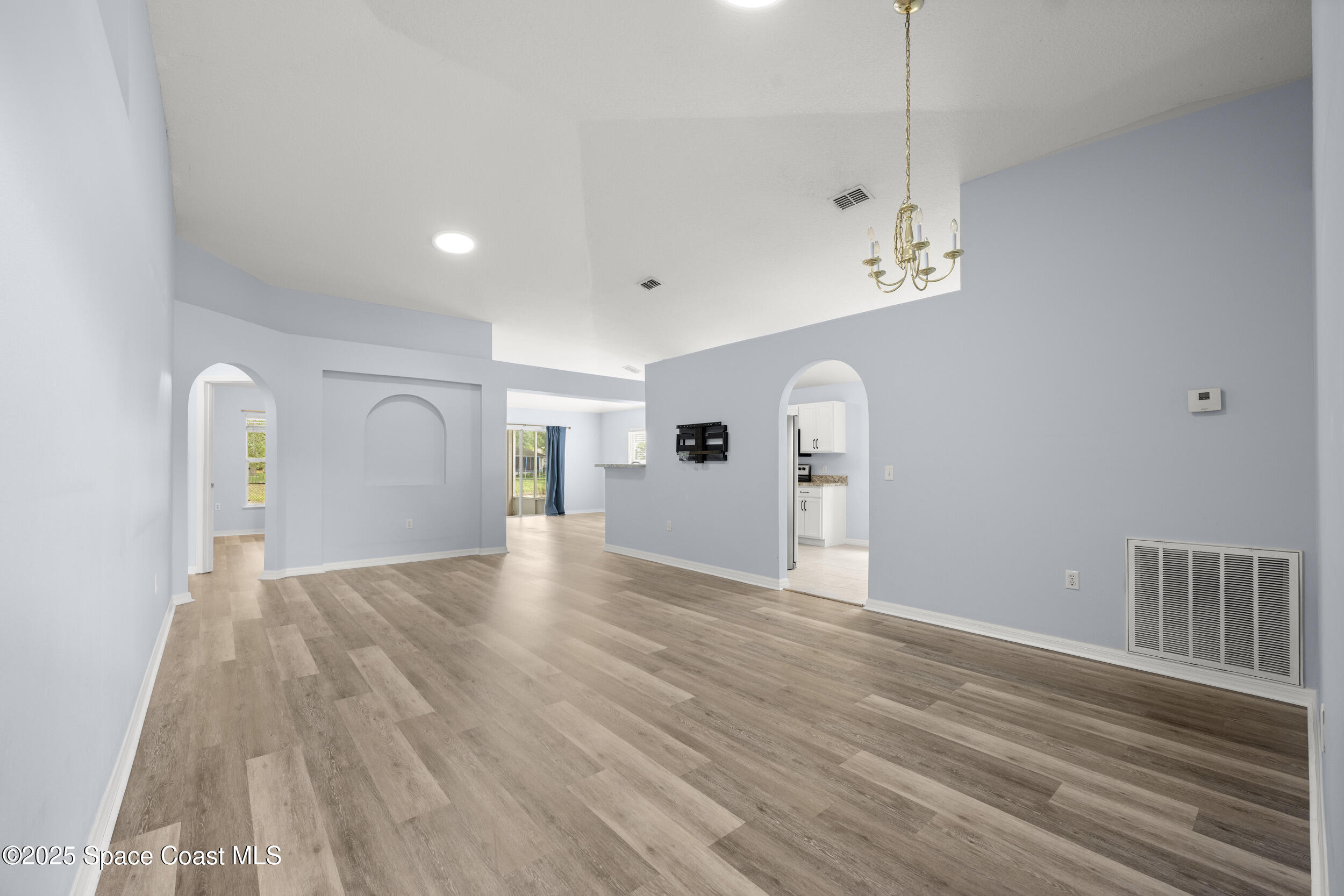2100 Canopy Drive Melbourne, FL 32935 - Photo 6 of 53 a view of empty room with wooden floor and window