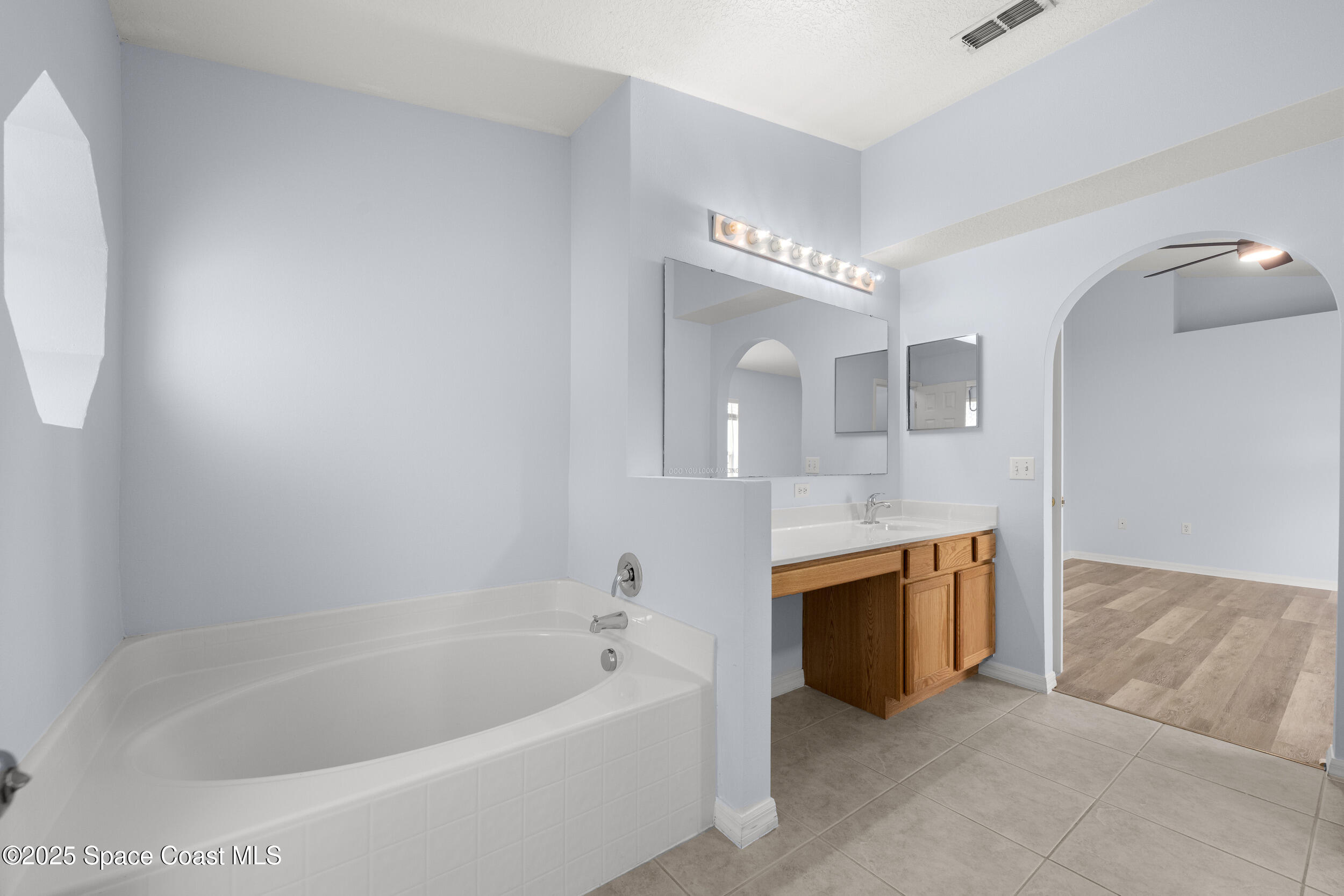 2100 Canopy Drive Melbourne, FL 32935 - Photo 9 of 53 a spacious bathroom with a bathtub and a sink