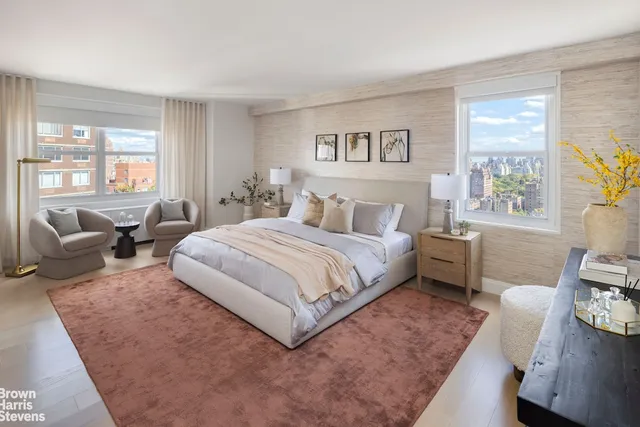 a spacious bedroom with a bed a couch and a potted plant on the dresser