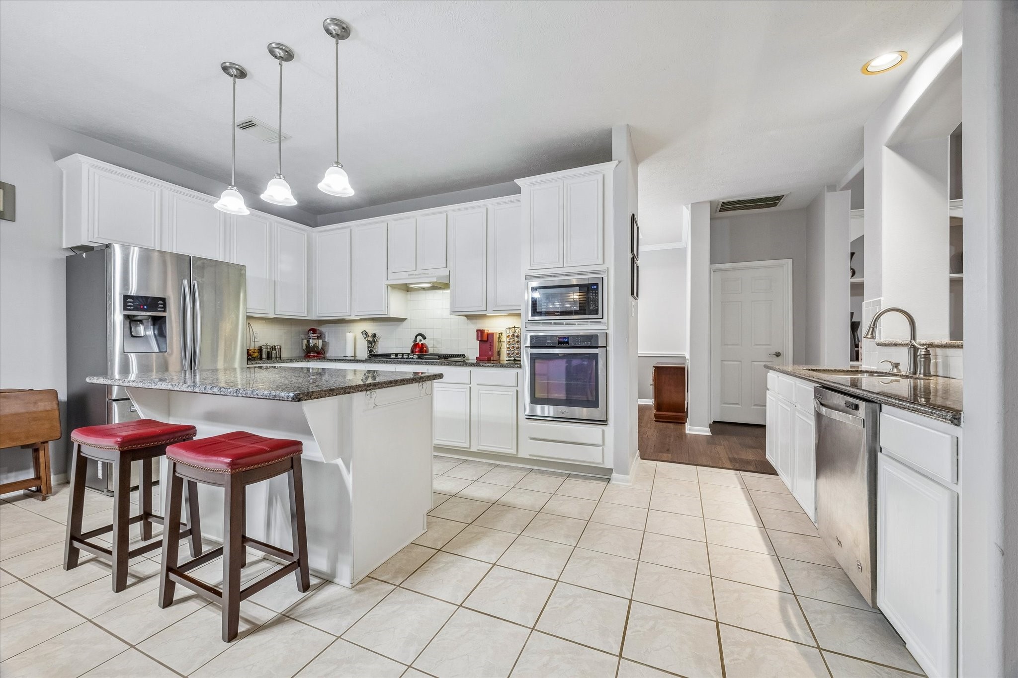 12423 Rutgers Park Court Houston, TX 77058 - Photo 11 of 29 a kitchen with stainless steel appliances a refrigerator sink and cabinets