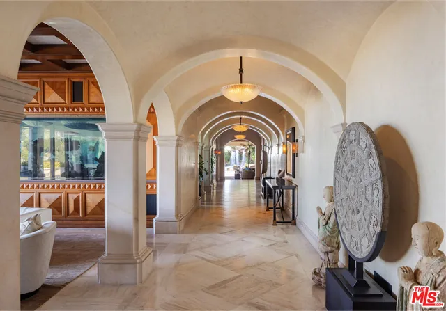 a living room with furniture and a floor to ceiling window