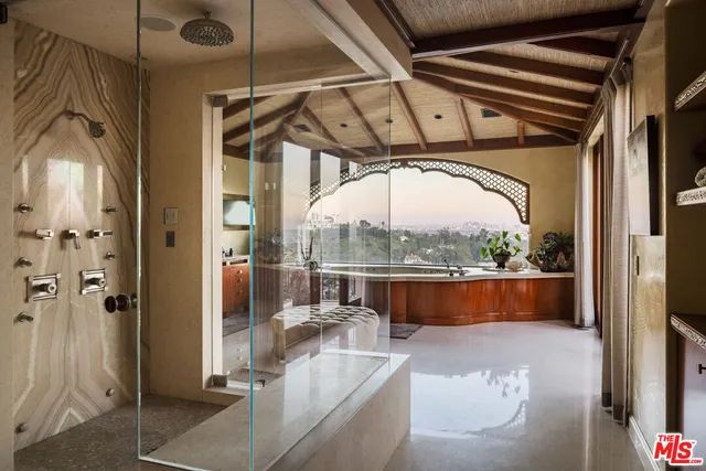 a living room with furniture a ceiling fan and a window