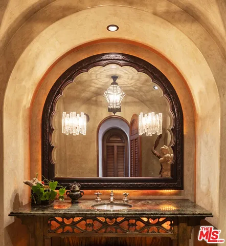 a view of kitchen with stainless steel appliances granite countertop furniture and a fireplace