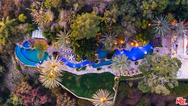 a kitchen with kitchen island granite countertop a sink a stove and cabinets
