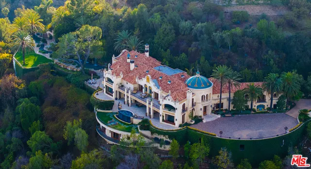 an aerial view of a house with outdoor space and pool