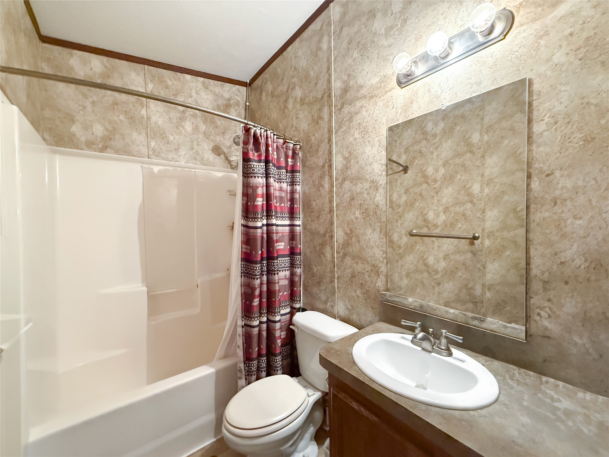 845 Caldwell Street Lexington, TX 78947 - Photo 14 of 39 Bathroom with toilet, crown molding, shower / bath combination with curtain, vanity, and tile walls
