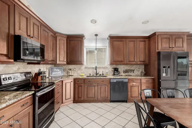 a kitchen with granite countertop sink stainless steel appliances and cabinets