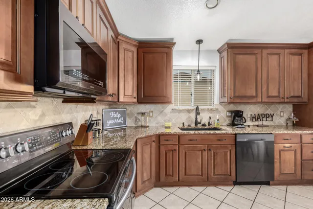 a kitchen with stainless steel appliances a sink stove and microwave