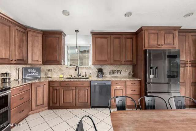 a kitchen with stainless steel appliances granite countertop a sink and cabinets