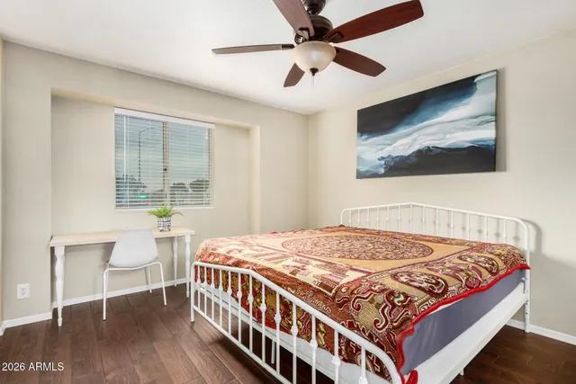 a bedroom with a bed and a window