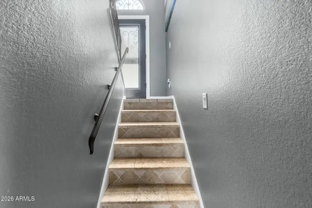 a view of staircase with white walls