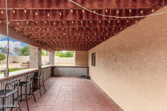a patio with table and chairs