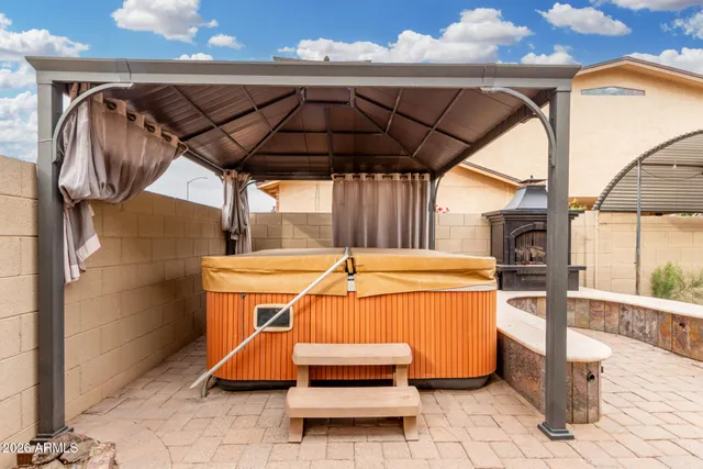 a blue swimming pool with a outdoor seating