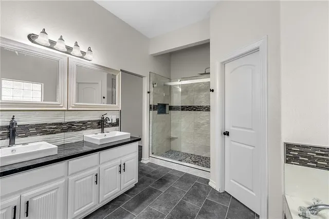 a spacious bathroom with a shower a sink and a mirror