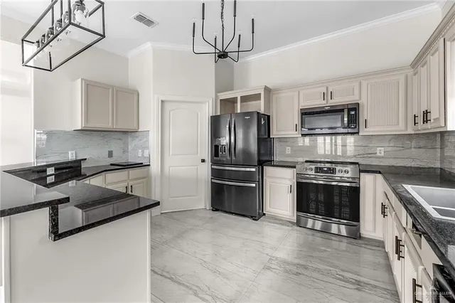 a kitchen with stainless steel appliances granite countertop a stove sink and refrigerator