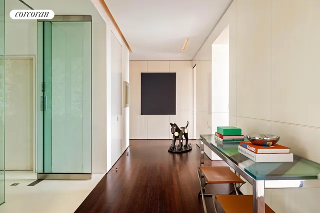 a view of a room with wooden floor and a window