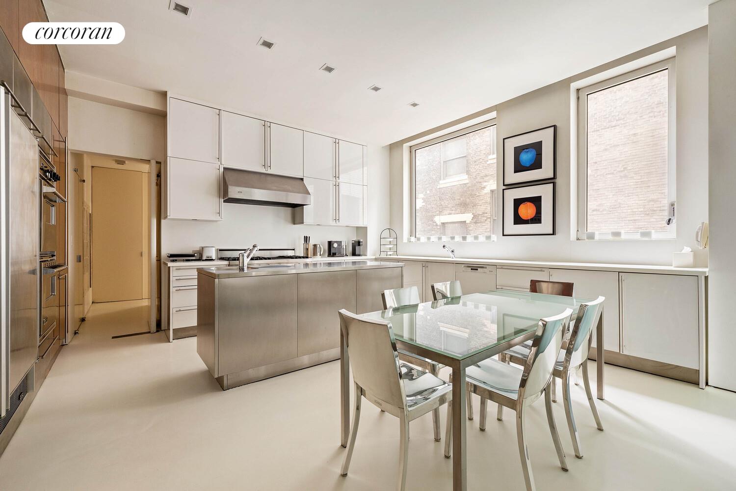 2 East 88th Street, Unit 10 Manhattan, NY 10128 - Photo 20 of 35 a kitchen with stainless steel appliances granite countertop a refrigerator and a stove top oven