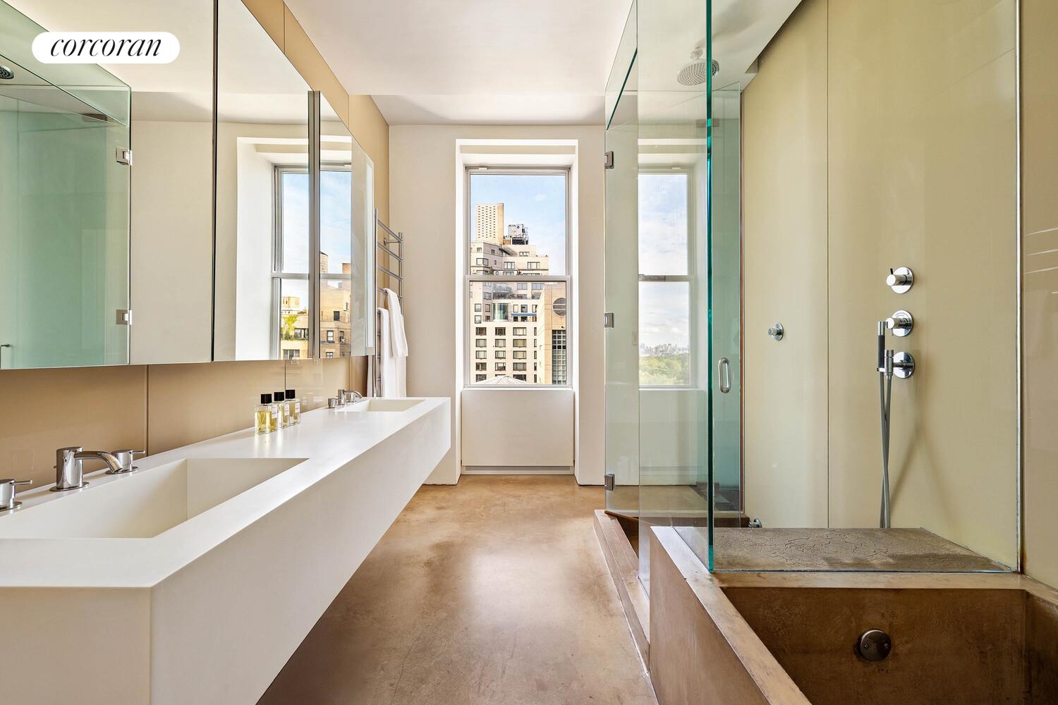 2 East 88th Street, Unit 10 Manhattan, NY 10128 - Photo 23 of 35 a spacious bathroom with a tub sink and mirror