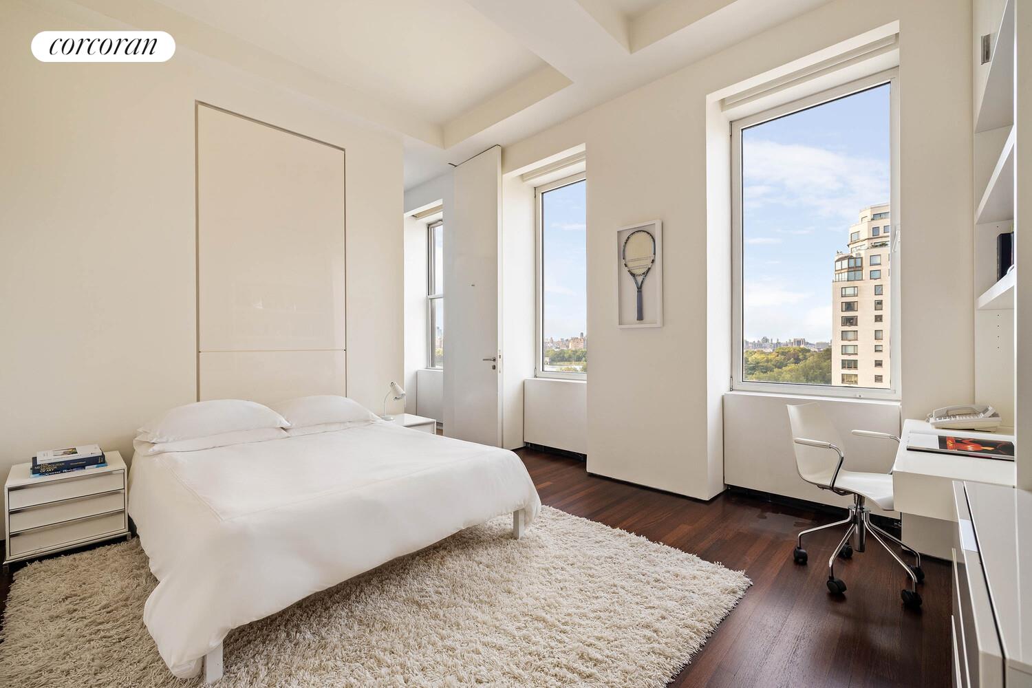 2 East 88th Street, Unit 10 Manhattan, NY 10128 - Photo 26 of 35 a bedroom with a bed a table and a large window