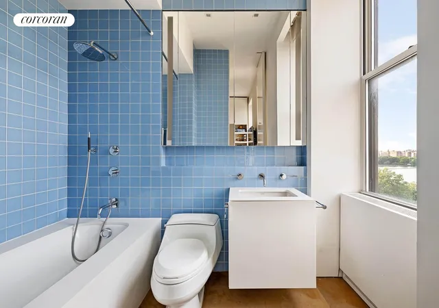 a bedroom with a bed a table and a large window