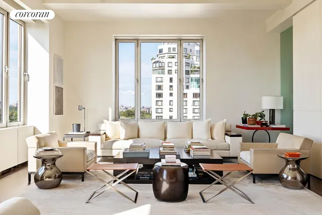 a living room with furniture and floor to ceiling windows