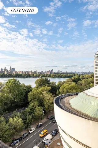 a living room with furniture large window and table