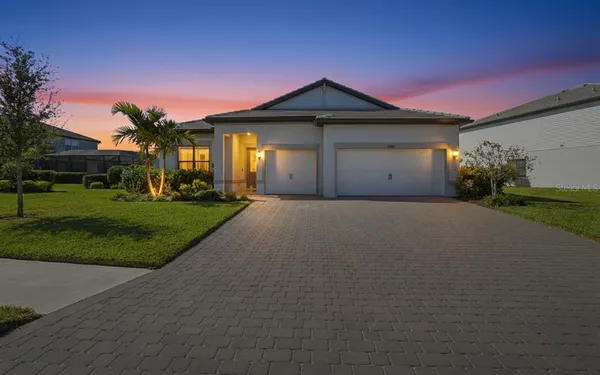 a front view of a house with a yard and garage